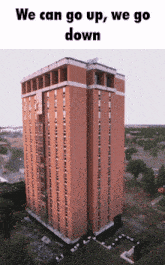 an aerial view of a tall brick building with the words we can go up we go down