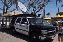 a sheriff 's vehicle is parked in front of a tent