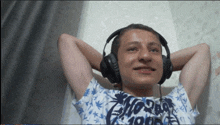 a young man wearing headphones and a shirt that says california