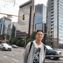 a young man standing in front of a building that says ' banco ' on it