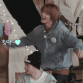a man wearing a black hat and a blue jacket is dancing