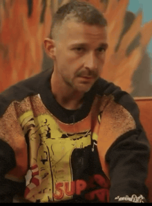 a man wearing a sweatshirt that says supreme on it