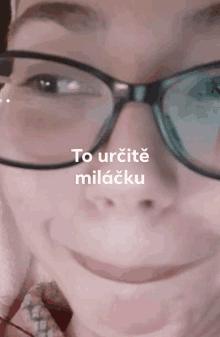 a close up of a woman wearing glasses with the words to urcite miláčku on the bottom right