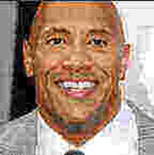 a man in a suit and tie is smiling in a pixelated portrait .