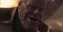 a close up of thanos ' face in avengers : infinity war with a beard .