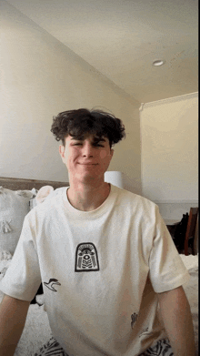 a young man wearing a white t-shirt with a skeleton on it