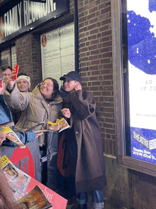 a group of people taking a selfie in front of a sign that says a family reunion