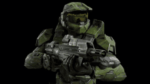 a man in a green helmet is holding a gun and wearing a goggles that say u.s. army