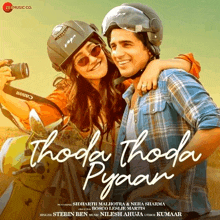 a movie poster for thoda thoda pyjaan shows a man and a woman on a motorcycle