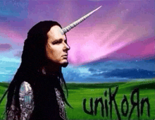 a man with a unicorn horn is standing in a field with the word unicorn written in black