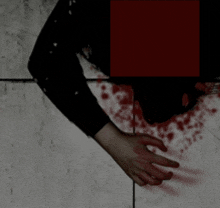 a person 's arm is shown with blood on it and a red square in the background