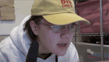 a person wearing a hat that says dig cheese