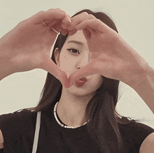 a girl making a heart shape with her hands