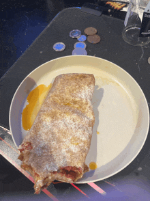 a white plate with a piece of food on it and a bottle of pepsi