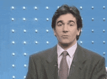 a man in a suit and tie with the words bien sur written on his face