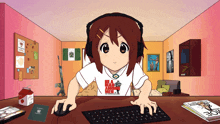 a girl wearing headphones and a red dead redemption shirt is typing on a computer keyboard