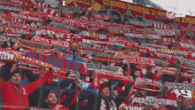 a crowd of people in a stadium holding up scarves with a banner that says ' polska ' on it