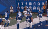 a group of giants football players celebrate a touchdown