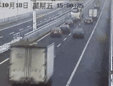 a truck is driving down a highway with a lot of cars .