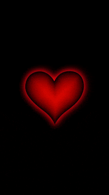 a red heart on a black background with a glowing center