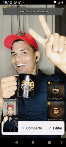 a man wearing a red hat is holding a black coffee mug