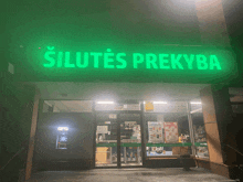 the front of a store with a green sign that says silutes prekyba