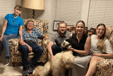 a family poses for a picture with a dog