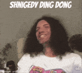 a man with long curly hair is smiling with the words shnigedy ding dong above him
