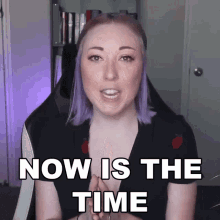 a woman with purple hair says " now is the time " while sitting in a chair