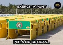 a row of yellow barriers with the words exercit a punt per a no se quan underneath