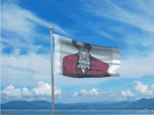 a flag with a picture of a man in a red suit