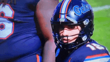 a football player wearing a helmet that says gator on it