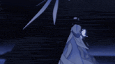 a person is standing in the dark with a feather in their hand