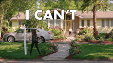 a woman is standing in front of a house with the words " i can 't " written above her