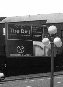 a black and white photo of a billboard that says the dirt