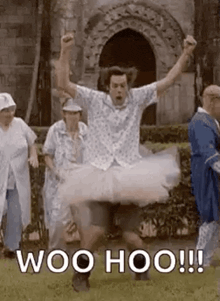a man is wearing a tutu and jumping in the air in front of a group of people .
