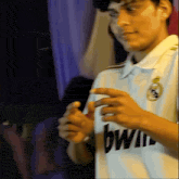 a man wearing a white shirt with the word bwi on the front