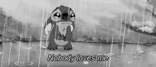 a black and white photo of a cartoon character crying in the rain with the words `` nobody loves me '' .