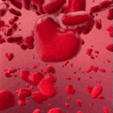 a bunch of red hearts are falling from the sky