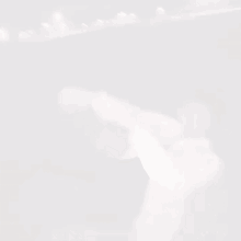 a blurry picture of a person in a white shirt