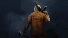 a man in a scum shirt is holding a gun and axe