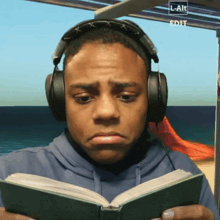 a man wearing headphones is reading a book with a watermark that says l- alt edit