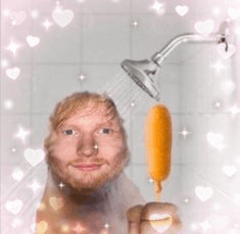 a man is taking a shower and holding an ice cream cone in his hand .