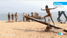 a woman in a bikini balances on a seesaw on a beach with the words " all stars got talent " on the bottom