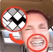 a close up of a man 's face with a red circle around his teeth