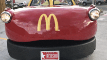 a red mcdonald 's car with a texas license plate that reads redshu