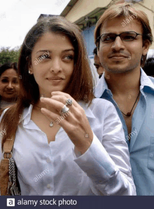 a man and a woman are standing next to each other .