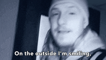 a blurry picture of a man with the words on the outside i 'm smiling below him
