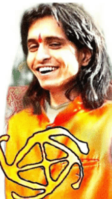 a man with long hair is smiling and wearing an orange jacket