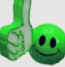 a hand is giving a thumbs up next to a green ball with a smiley face on it .